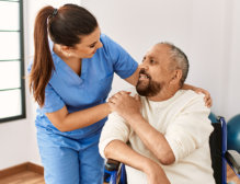 elderly man holding the caregiver's hand