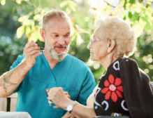 health aide feeding the elderly woman