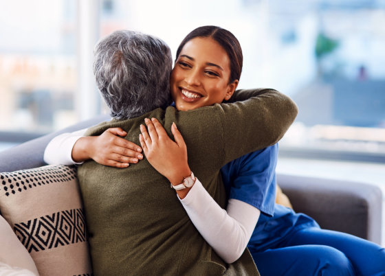 caregiver hugging the elderly woman