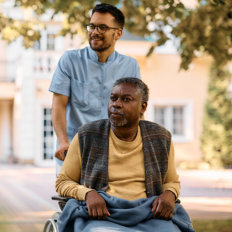 caregiver and elderly woman spending time outside