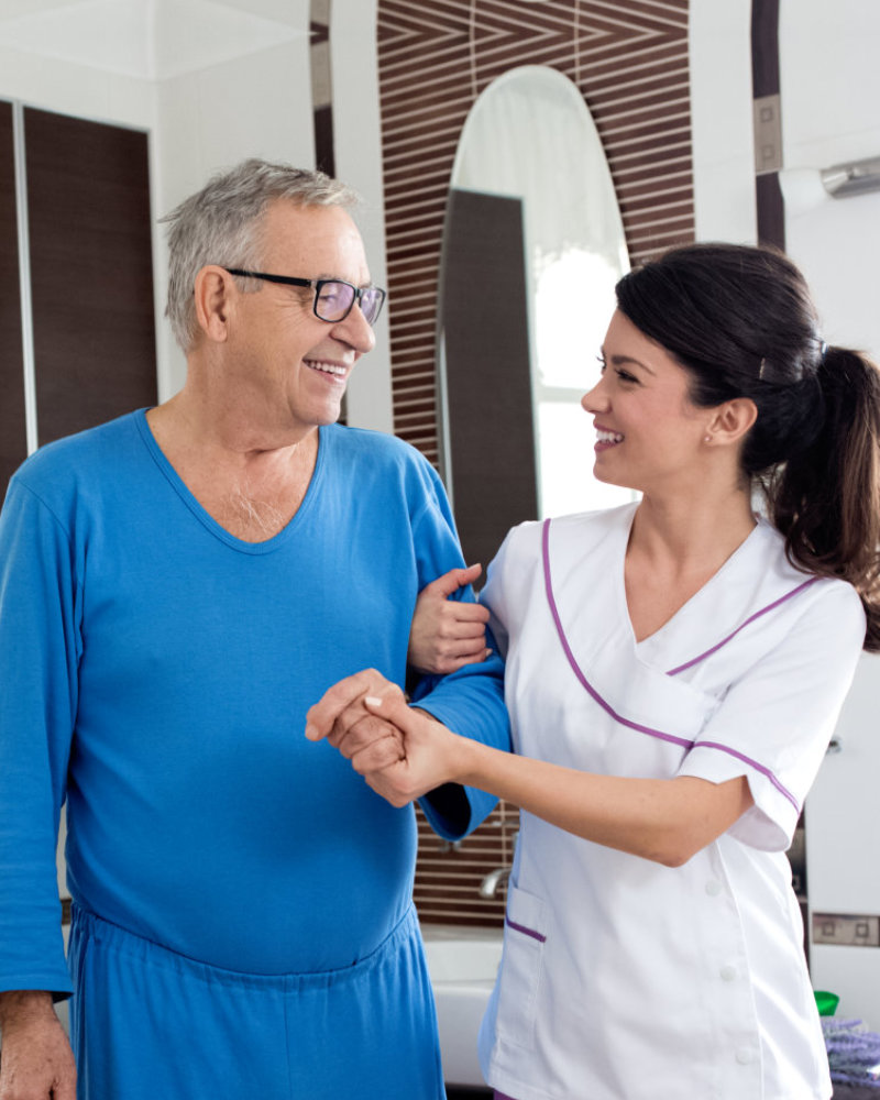 caregiver holding the senior man