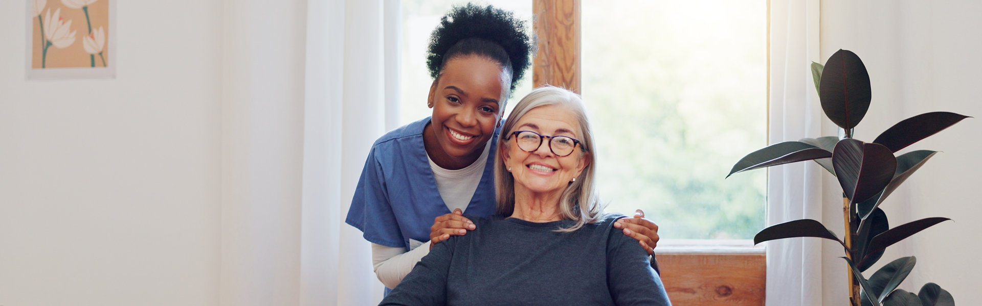 caregiver and elderly woman wearing glasses