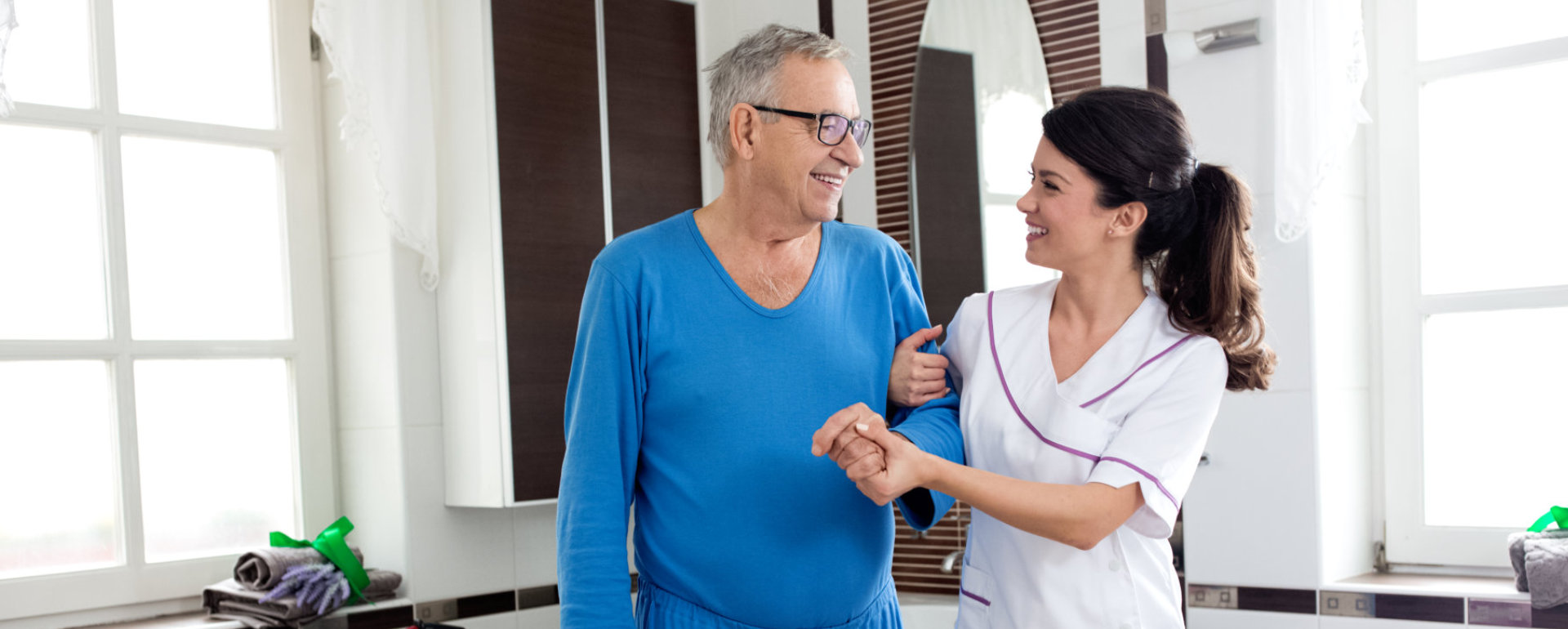 caregiver holding the senior man