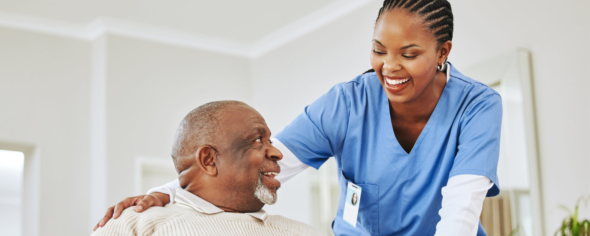 elderly man holding a cane with his caregiver