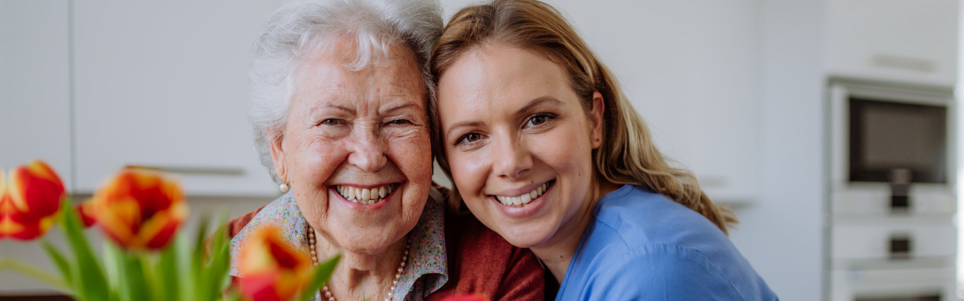 healthcare aide hugging the elderly woman