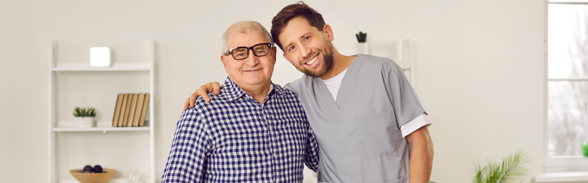 elderly man and caregiver smiling