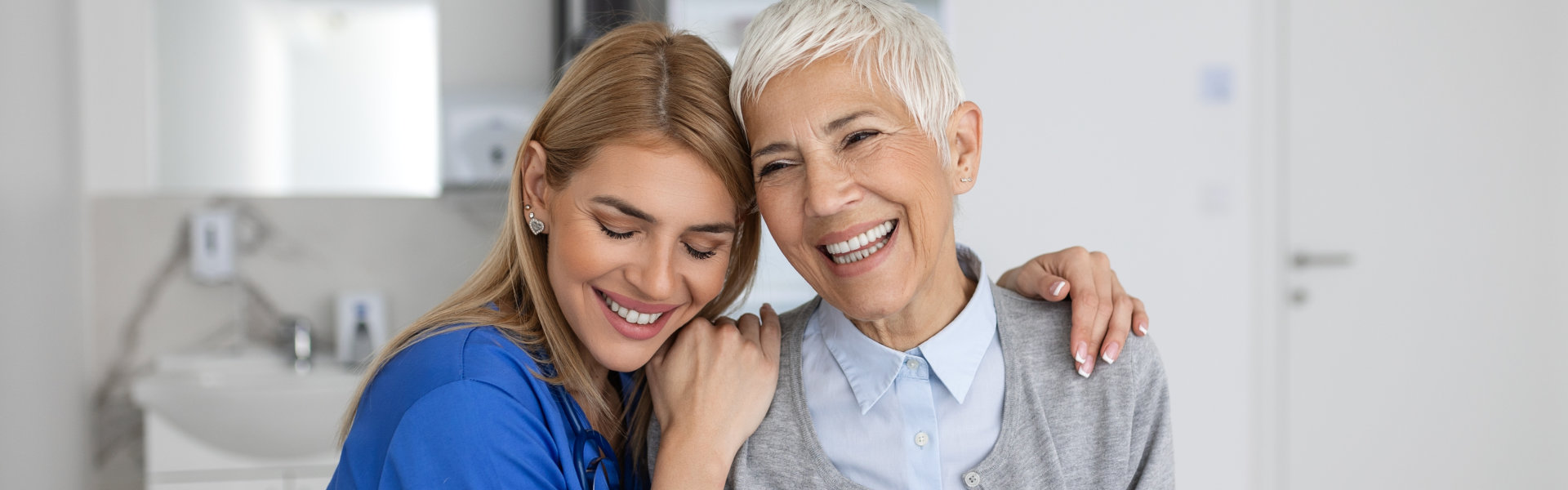 caregiver hugging the elderly woman